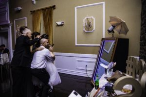 Guests interacting with the Mirror Booth's touch screen capabilities
