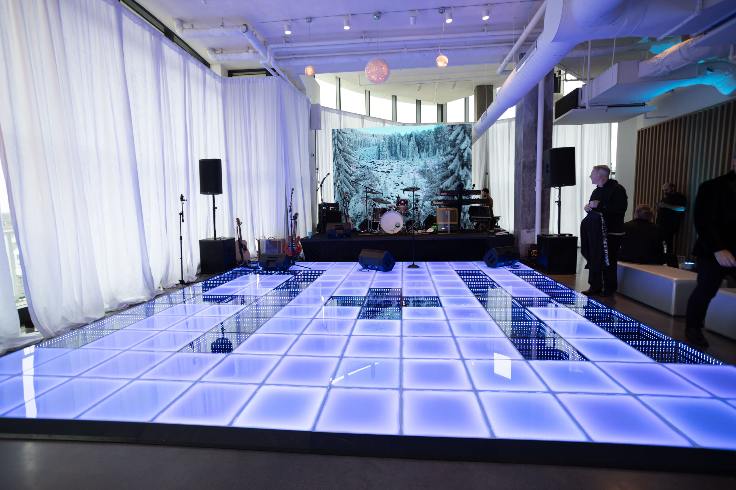 Wedding stage with instruments and mobile dance floor.