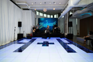 Elegant LED dance floor lighting up a wedding venue.