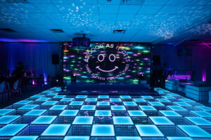 Guests enjoying a wedding party on a beautifully lit LED dance floor.