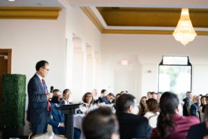 Key speakers engaging with attendees at a corporate event.