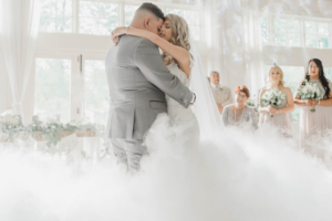 Couple dancing on clouds during their wedding for a magical first dance moment.