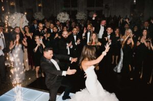 Guests dancing at a wedding with DJ-led music.