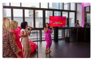 Women singing together at a corporate karaoke event