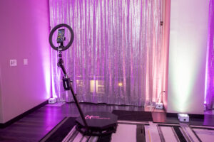 Open air photo booth with a themed backdrop at a disco party.