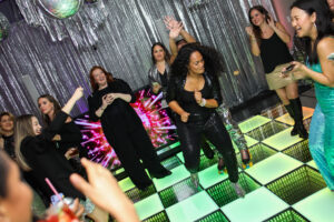 Guests dancing together during an engaging dance floor activity.