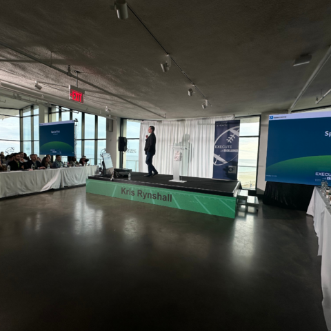Custom stage backdrop at a corporate product launch event with branded visuals.