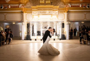 Bride and groom enjoying their first dance with sparkler machines creating a dramatic light show.