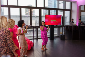 Employees singing at a karaoke-themed corporate event, showcasing fun ideas for corporate events that encourage participation.