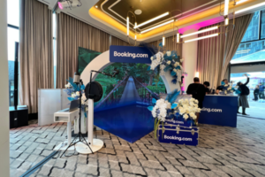 Booking.com tropical event with custom arch and branded decor