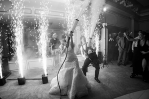 Bride and groom having fun at their wedding with special effects, showcasing creative photography moments during the celebration.