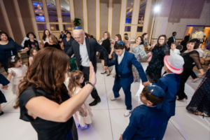 Guests dancing and celebrating at a bar mitzvah, marking the boy's entrance into Jewish adulthood