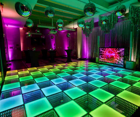 LED dance floor with bright colors at a disco-themed event