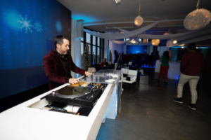 DJ mixing tracks at an event using professional equipment.