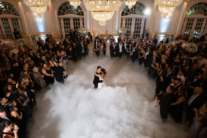 Couple’s last dance for wedding surrounded by a dreamy fog effect, creating a ‘dancing on the clouds’ ambiance