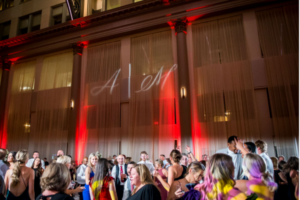 Monogram lighting projected on a wall in a wedding reception venue