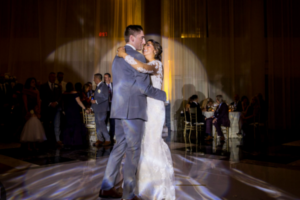 Couple’s first dance highlighted by pin spot lighting at a wedding