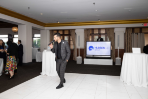 DJ performing at a corporate marketing event with branded elements.