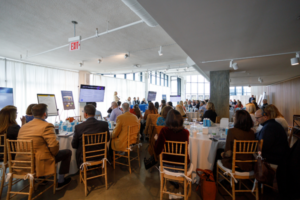 Speaker addressing an audience at a marketing event with an optimized seating arrangement.