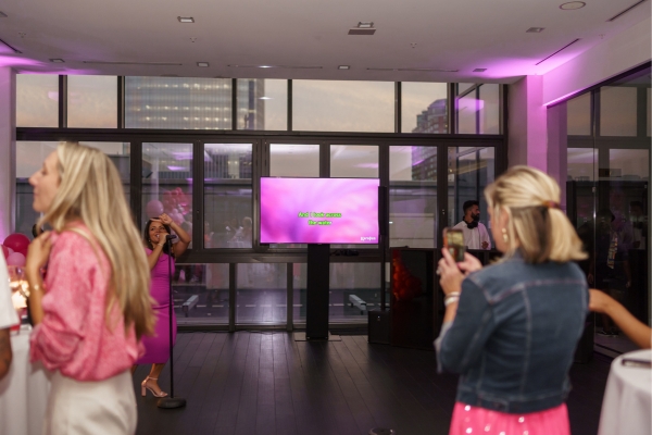 Audience watching a karaoke performance with lyrics on a big screen.
