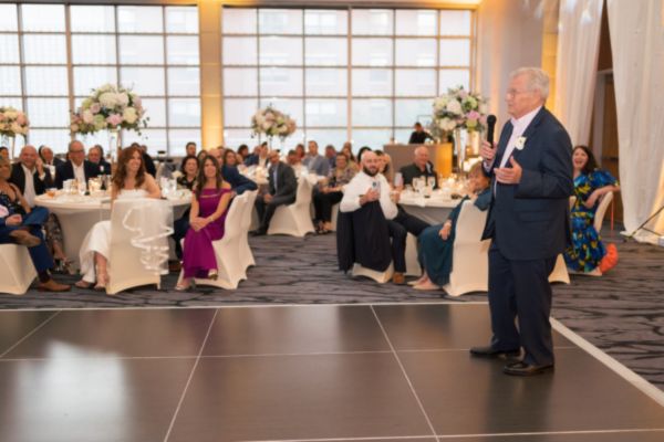 Father of the bride gives a speech at the wedding reception.g