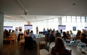 A panel of speakers at a corporate conference.
