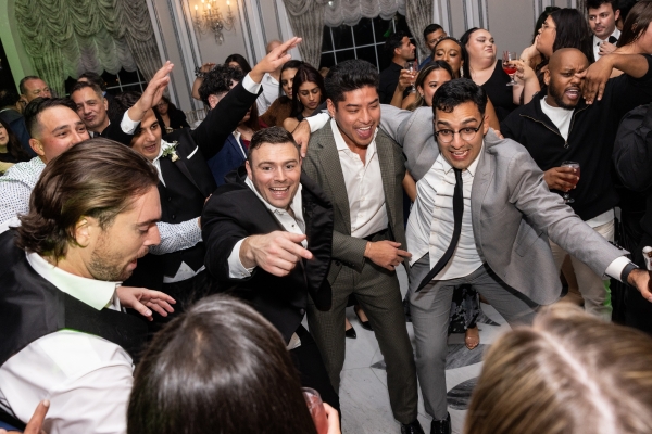 Guests dancing and celebrating on the packed dance floor.