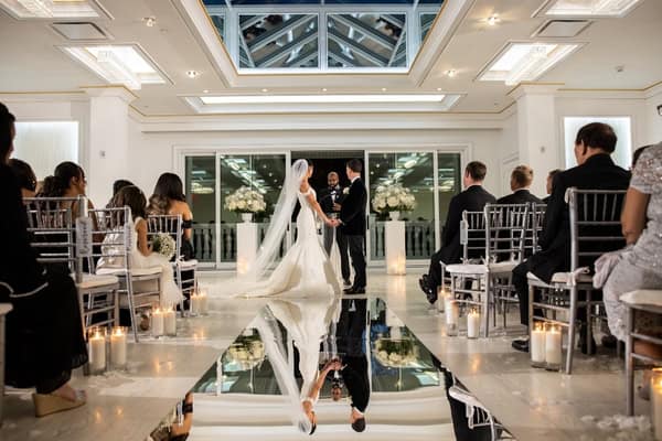 Bride and groom exchanging vows in an elegant venue.