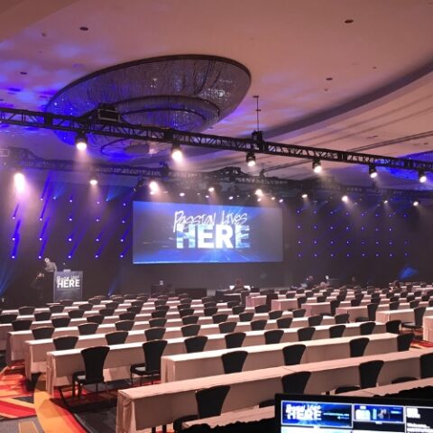 Large-scale LED video wall at a corporate conference.