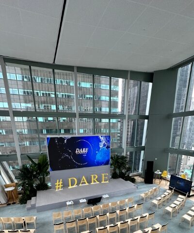 Corporate conference with large LED screen.