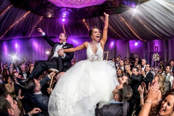 Guests dancing to must-play songs from the wedding DJ checklist