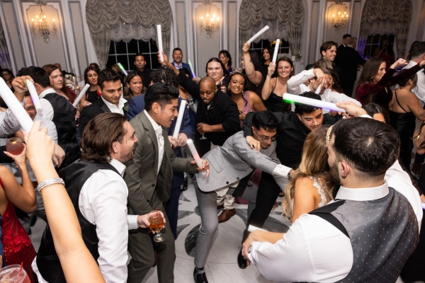 Wedding guests dancing on dance floor during reception