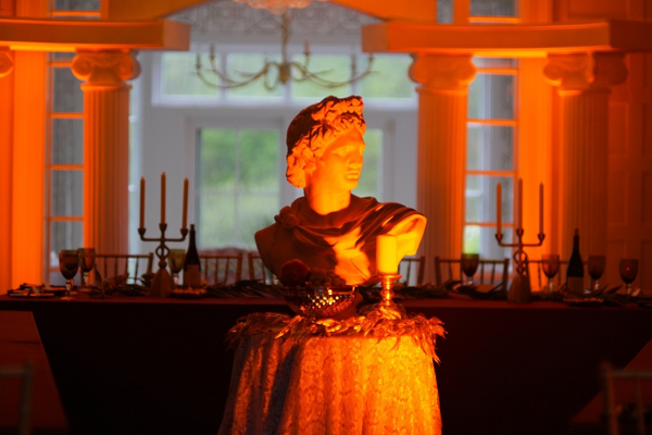 Roman statue centerpiece with orange lighting