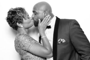 Couple kissing in glam photo booth