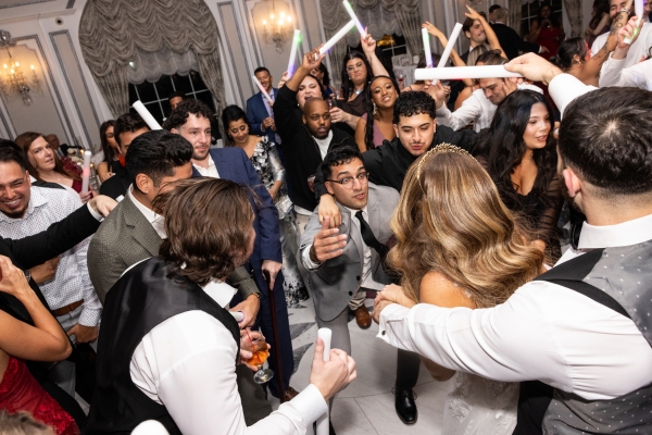 Wedding guests dancing with glow sticks