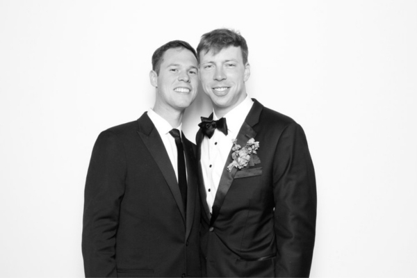 Two grooms posing in glam photo booth