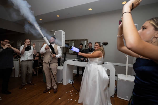Bride firing CO2 cannon at wedding DJ booth