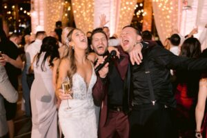 Couple singing with wedding MC