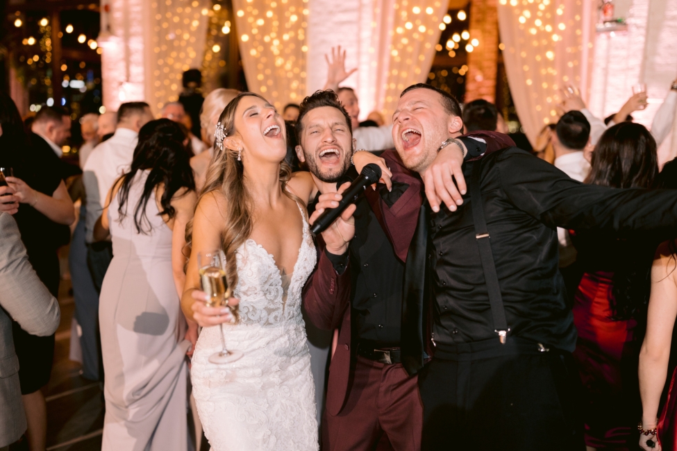 Couple singing with wedding MC