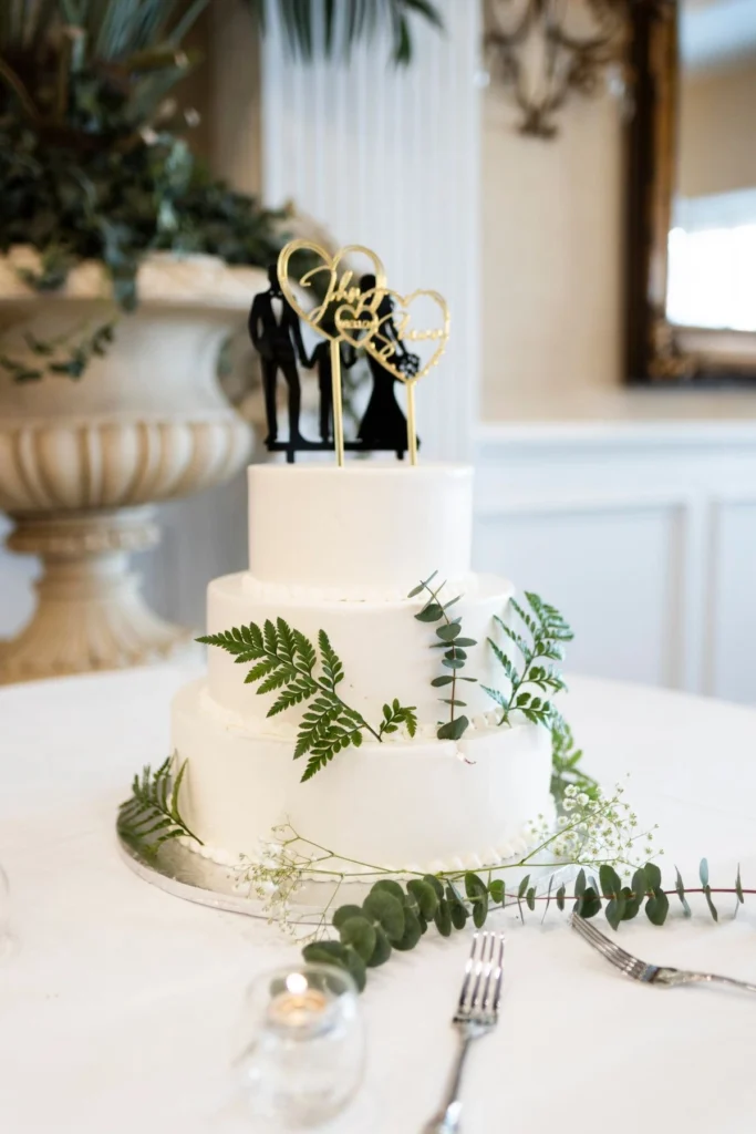 White wedding cake with greenery