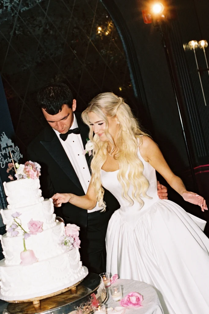 Couple cutting wedding cake