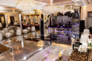 Event stage and scenic setup beneath ballroom chandeliers