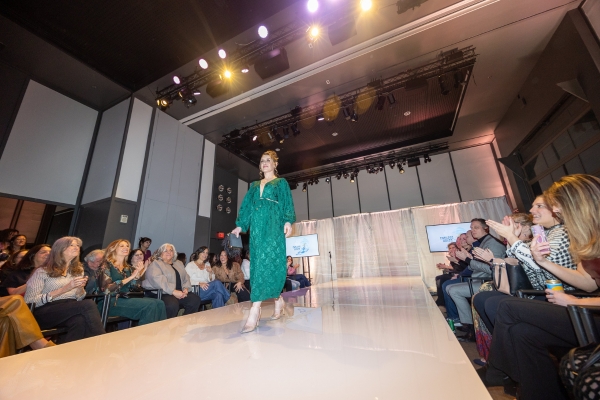 Model walking down white thrust stage runway